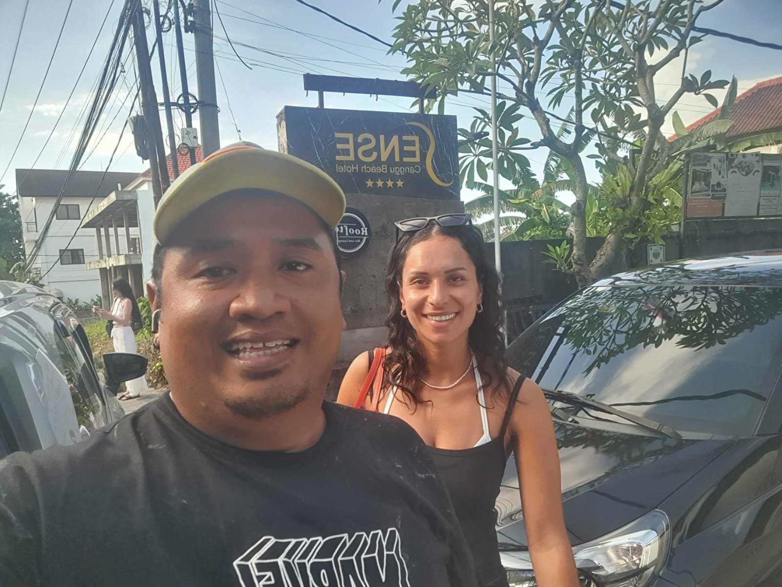 Bali Driver 24 with a happy customer outside a beach hotel in Canggu